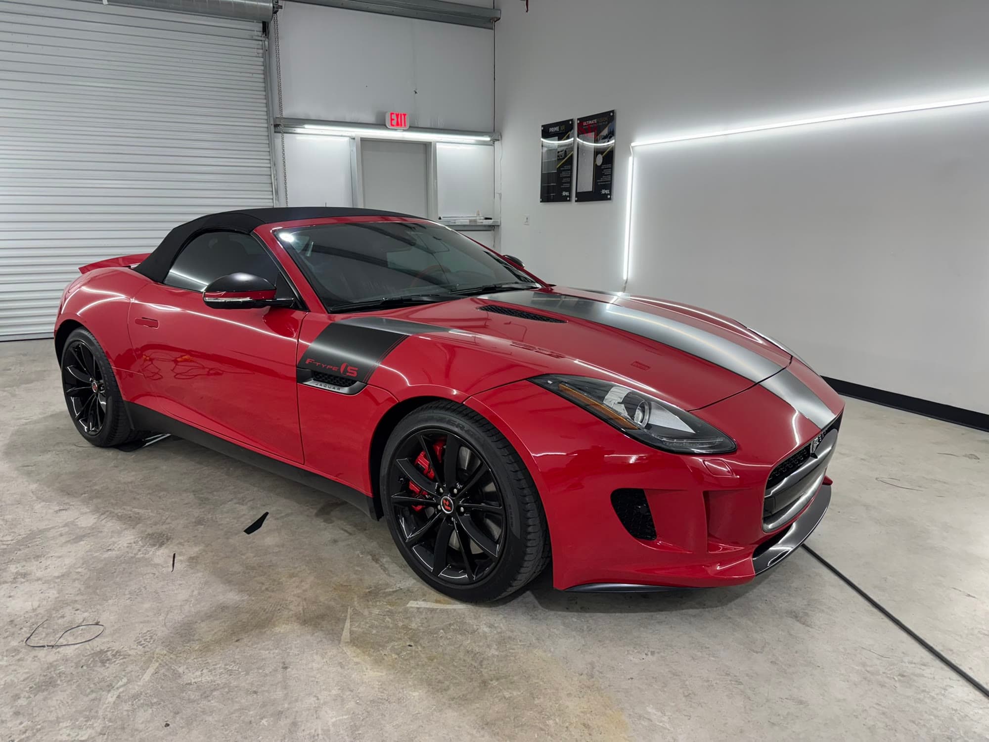 Red Jaguar F-Type with a satin gray and black center stripe running the length of the hood