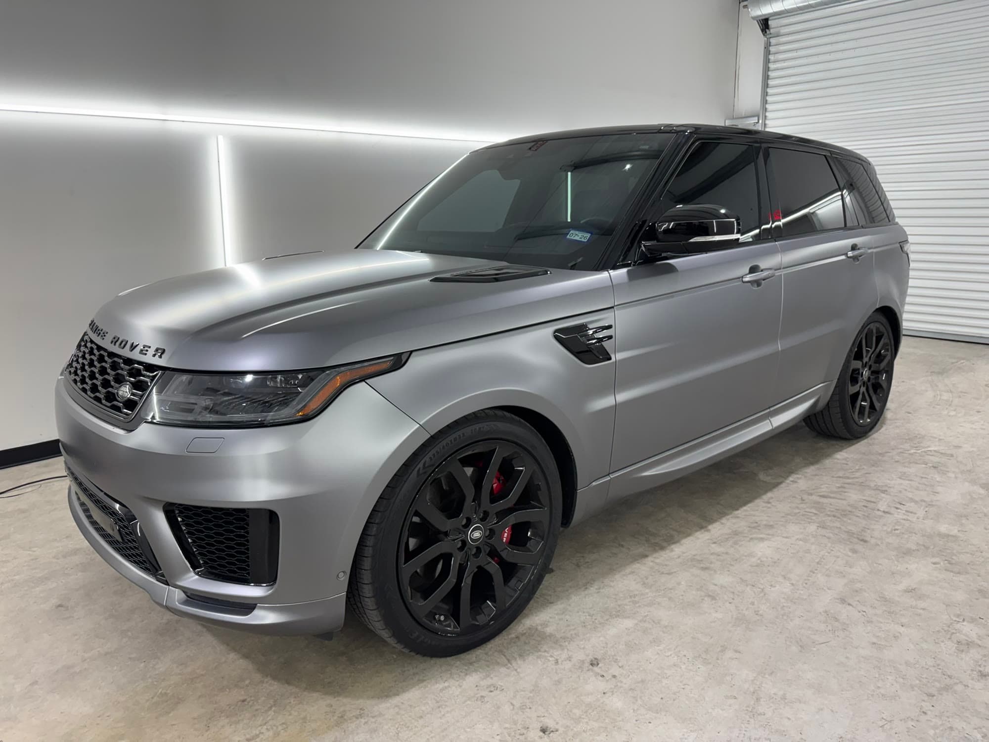 Range Rover Sport finished in a satin silver vinyl wrap with gloss black trim and wheels