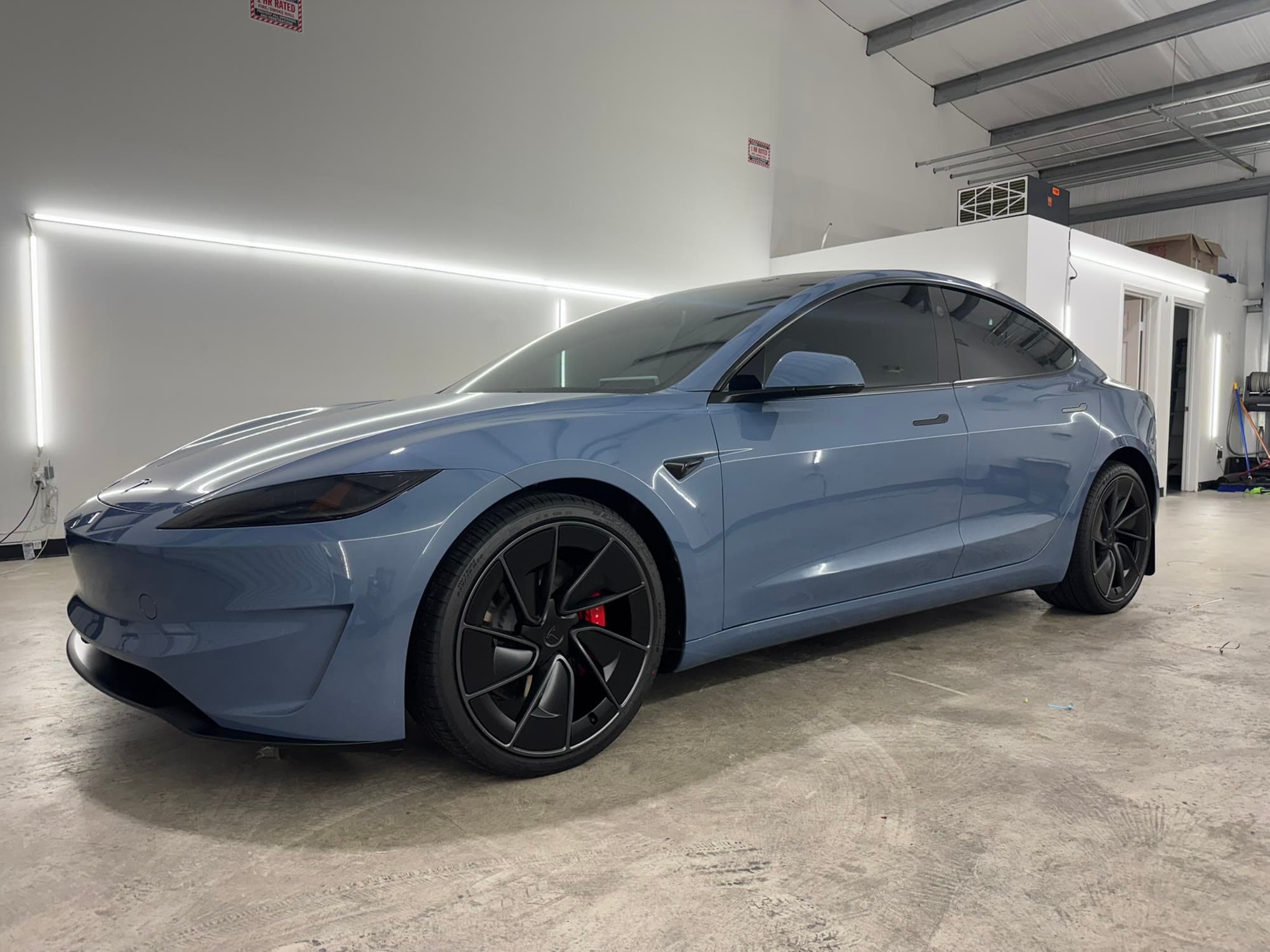 Blue Tesla Model 3 Performance in profile, showing a clean protected finish along the full body line